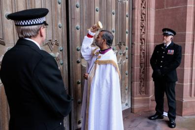 Bishop John knocking on the door of Liverpool Cathedral