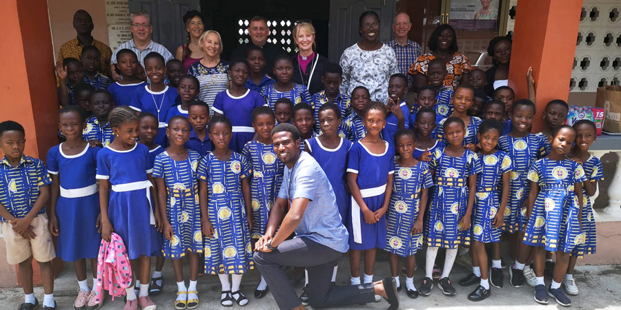 Bishop of Warrington Bev Mason and others visiting a school in Ghana